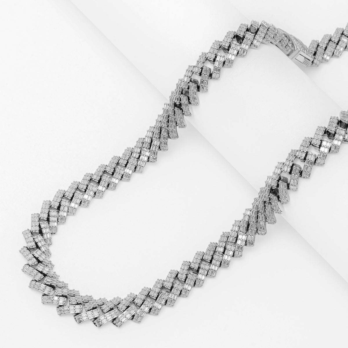 Big Daddy 12MM baguette Cuban CZ silver chain laid flat on white surface