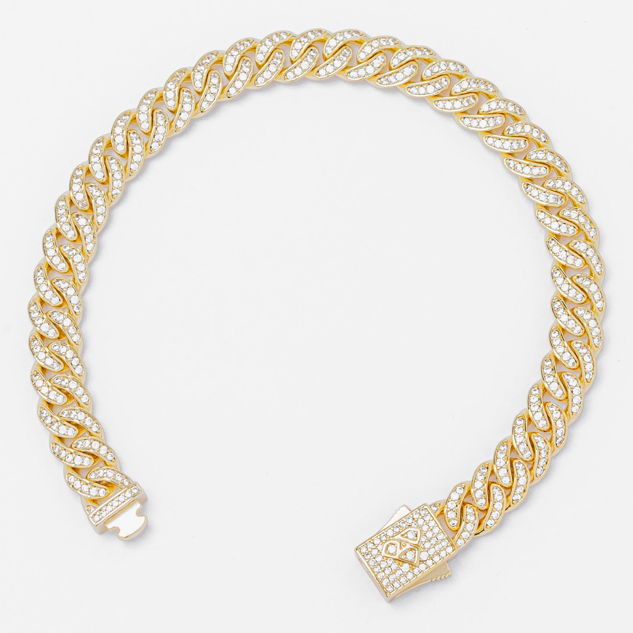 Cuban gold chain bracelet showcasing spiral link pattern with CZ-encrusted box clasp