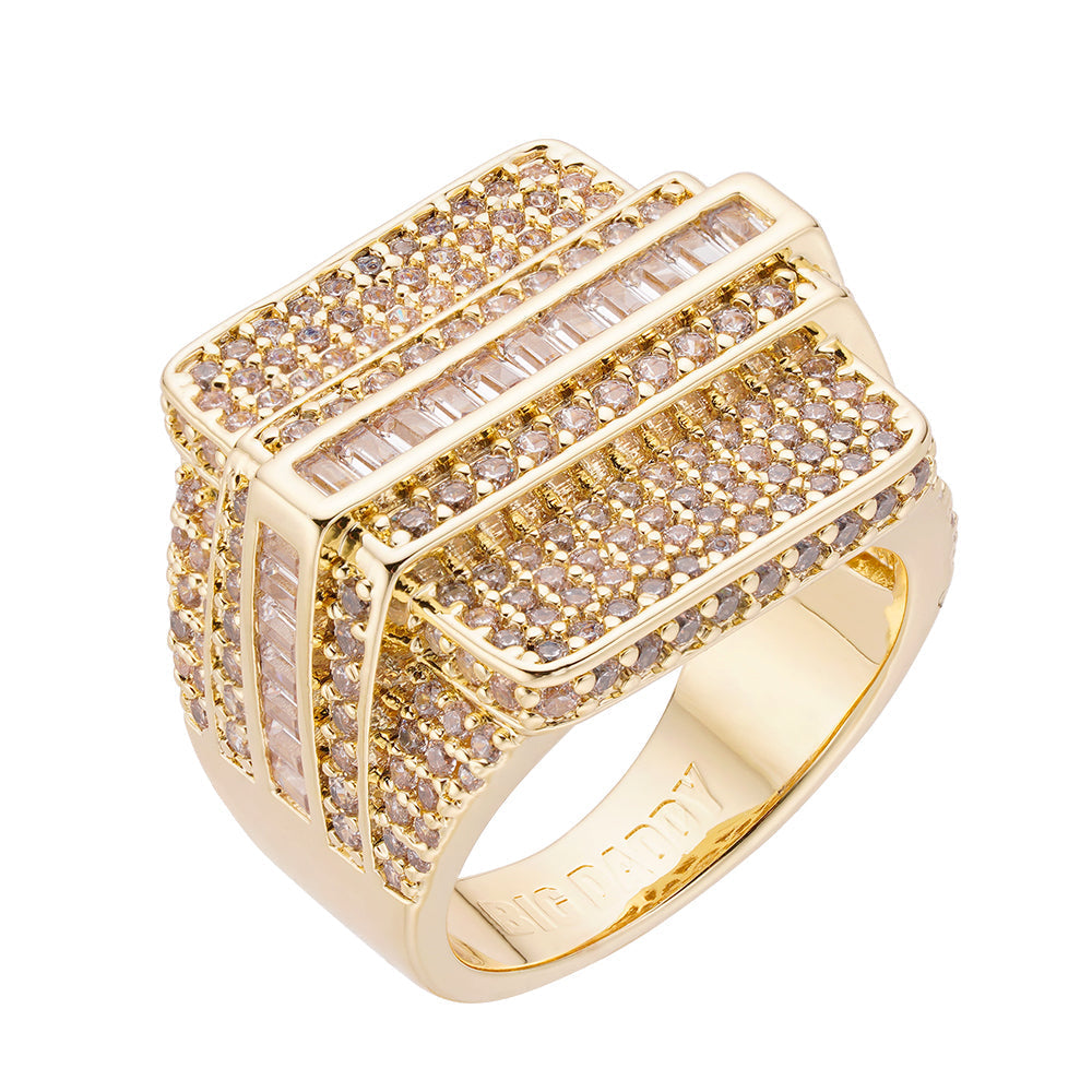 Gold-plated iced out baguette CZ ring with round and baguette-cut stones on white background