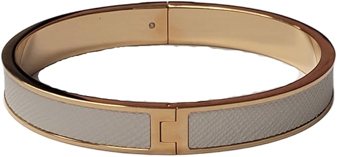Tory Burch white and gold bangle with gold-tone logo plaque closure