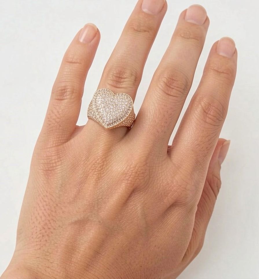 Gold heart iced out ring worn on hand, showing size and fit
