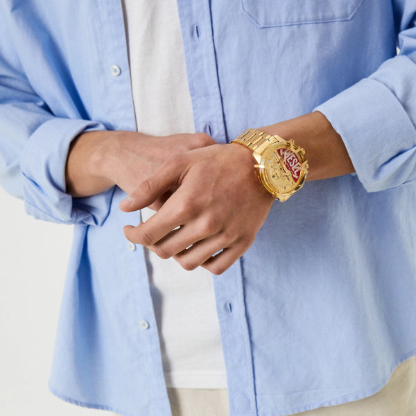 Diesel Griffed DZ4595 gold chronograph watch worn on wrist with light blue dress shirt