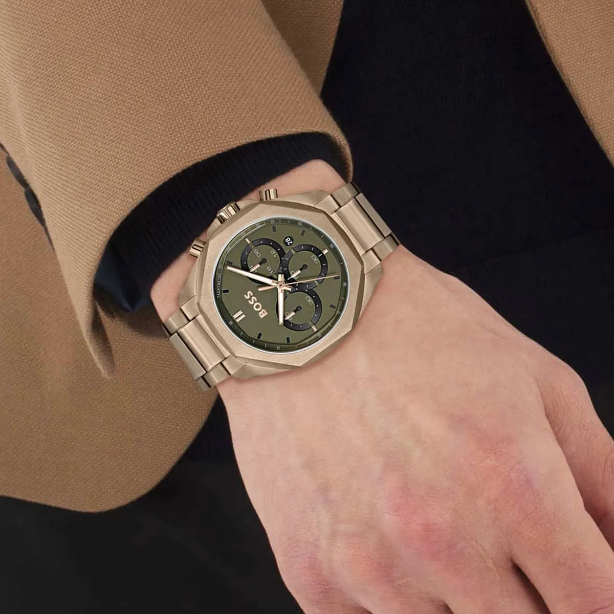 Hugo Boss 1514019 chronograph watch on wrist showing olive green dial and beige gold bracelet
