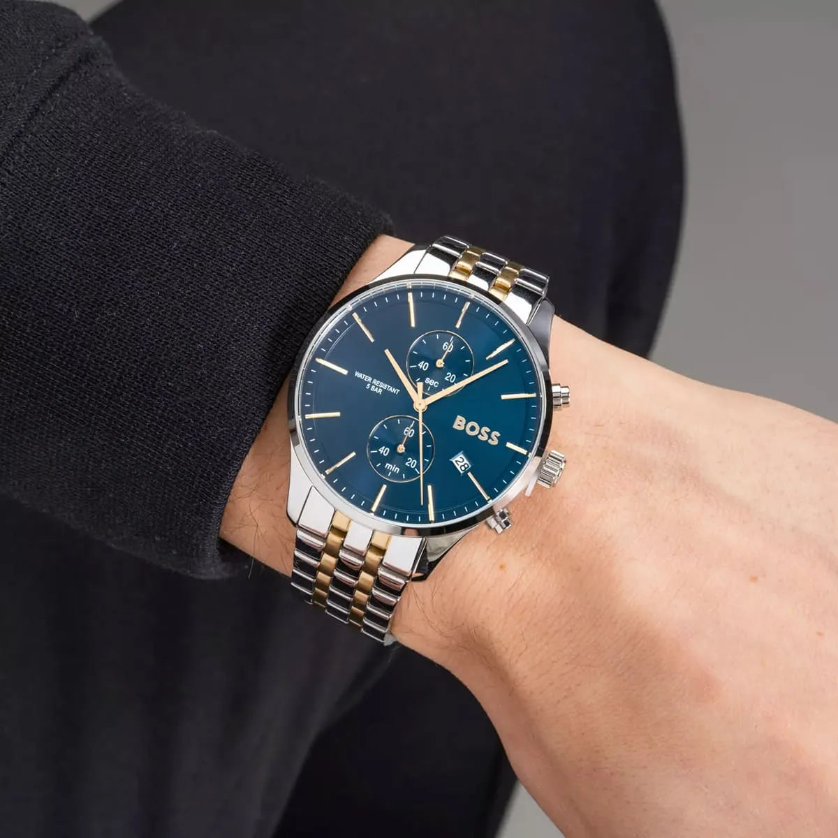 Hugo Boss Associate chronograph watch worn on wrist showing blue dial and two-tone strap