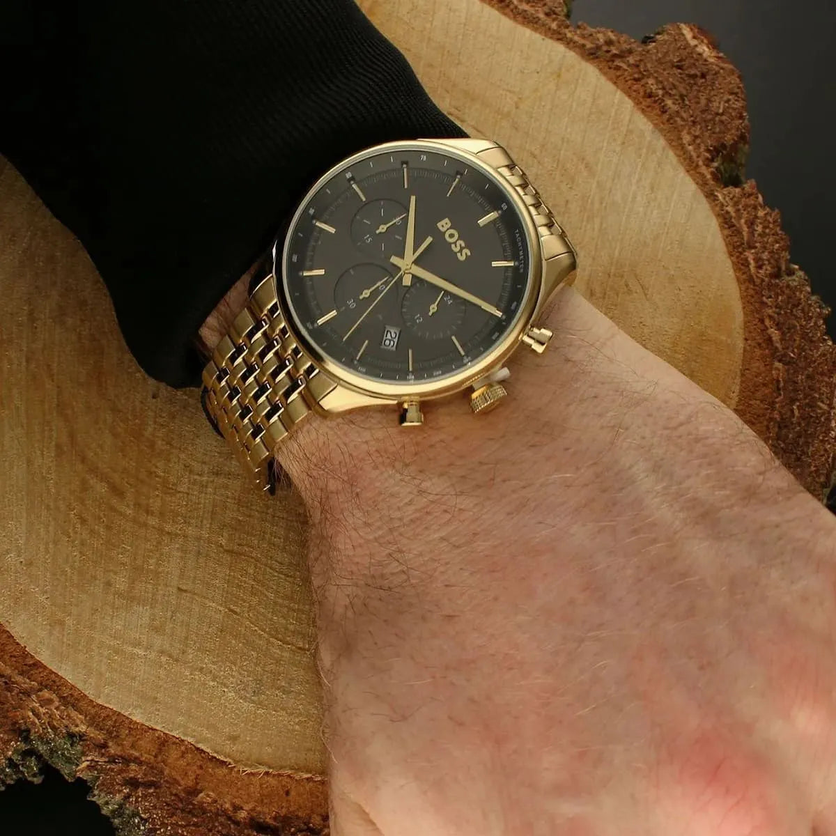 Hugo Boss Gregor chronograph watch worn on wrist with gold bracelet and grey dial