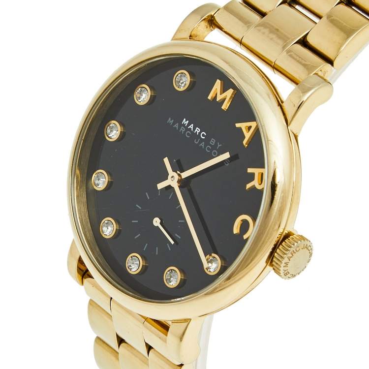 Angled view of Baker Dexter watch showing black dial with diamond markers and gold bezel