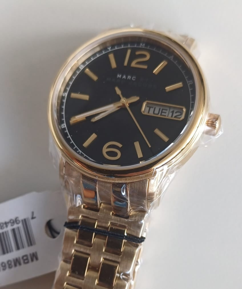 Marc by Marc Jacobs MBM8651 watch worn on wrist with gold-tone stainless steel bracelet