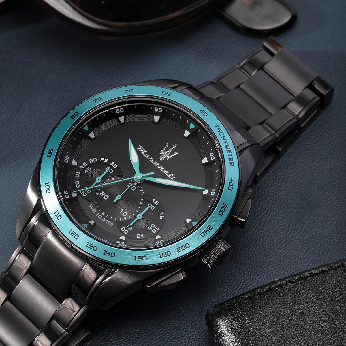 Maserati Traguardo chronograph watch worn on wrist with turquoise bezel and black dial