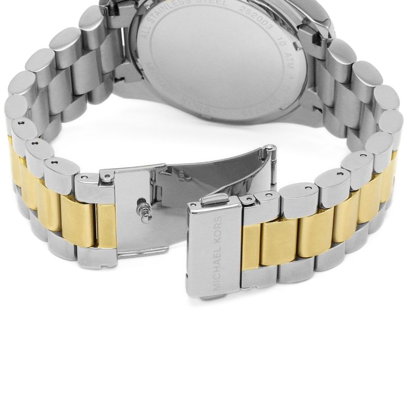 Caseback of Michael Kors Bradshaw watch showing stainless steel case and two-tone bracelet