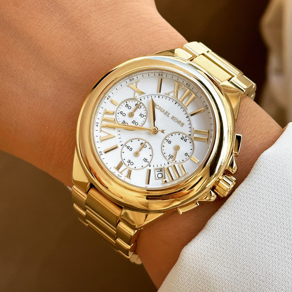 Michael Kors Camille chronograph watch worn on wrist showing white dial and gold case