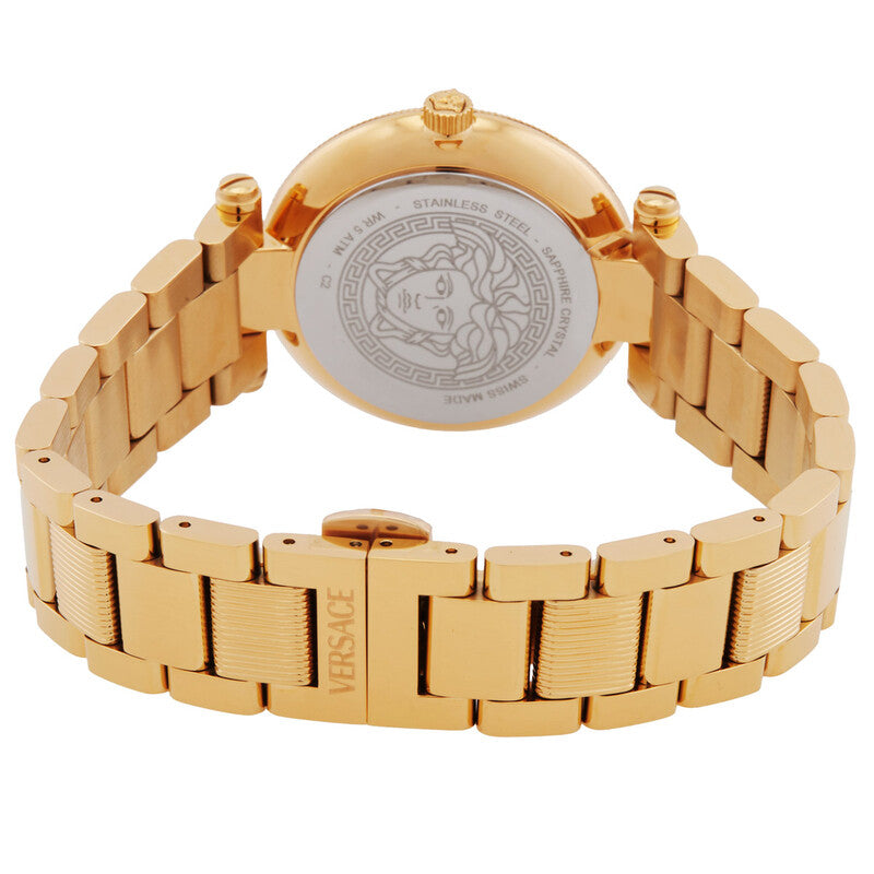 Gold-tone stainless steel women's watch shown from the back, featuring a round case, polished link bracelet, and a central circular dial with an engraved Medusa head and Greek key motif. The clasp is engraved with 'VERSCHGA'.