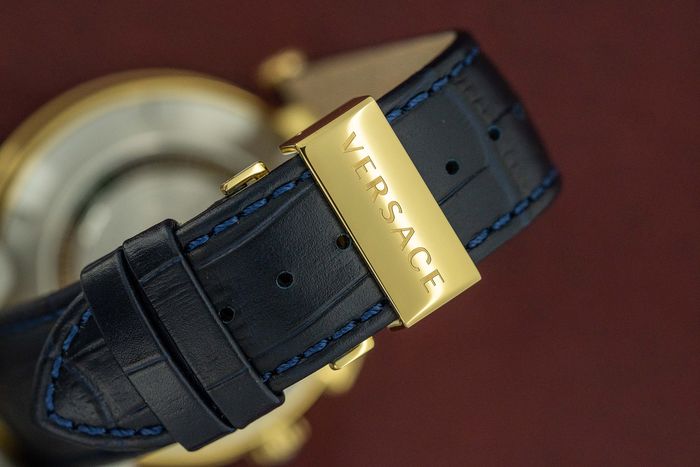 Close-up of Versace V-Race blue leather strap with gold-tone buckle clasp